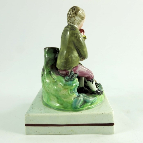 1569 - A Staffordshire figure of a boy with cockerel, circa 1820, on square plinth base, 12.5cm high