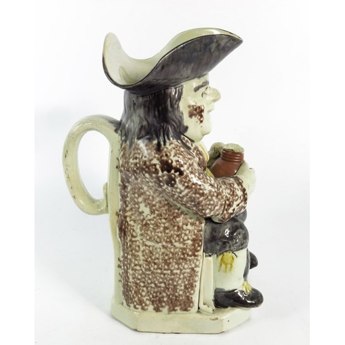 1570 - A Staffordshire Toby Jug, 18th century, sponge decorated in yellow and puce, 26cm high