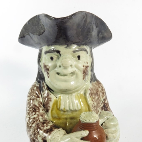 1570 - A Staffordshire Toby Jug, 18th century, sponge decorated in yellow and puce, 26cm high