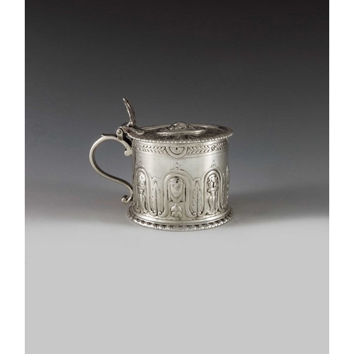 2084 - Eliza Godfrey, London 1762, a George III silver mustard pot of cylindrical form, heavily decorated w... 