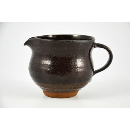 1428 - Margaret Leach for Wye Valley, a studio pottery jug, brown treacle glaze, impressed mark, 9cm high