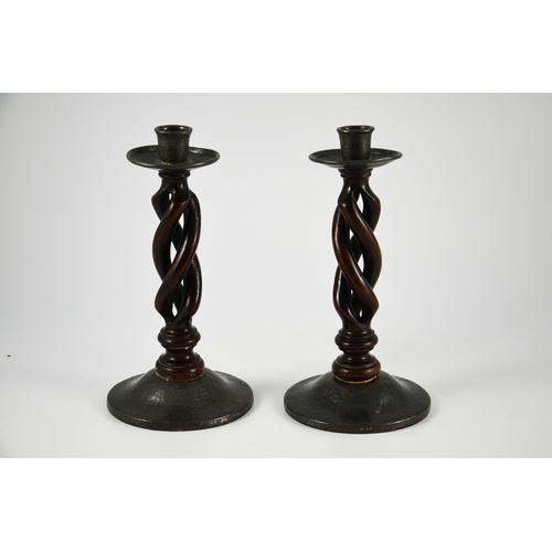 617 - Liberty and Co., pair of Tudric pewter and oak candlesticks, model 01298, open barley twist with pla... 