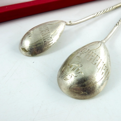 12 - A pair of Imperial Russian spoons, circa 1912, the bowls engraved with a flower and Cyrillic, cased,... 