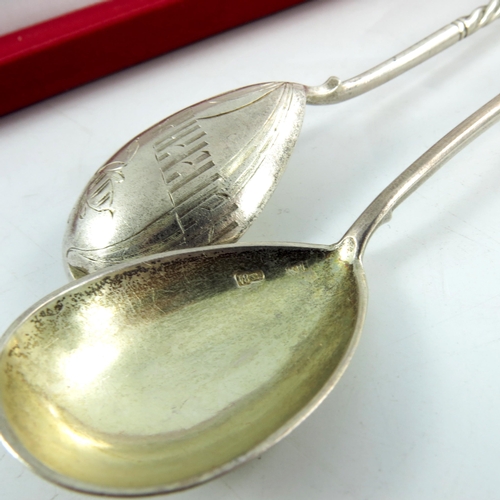 12 - A pair of Imperial Russian spoons, circa 1912, the bowls engraved with a flower and Cyrillic, cased,... 