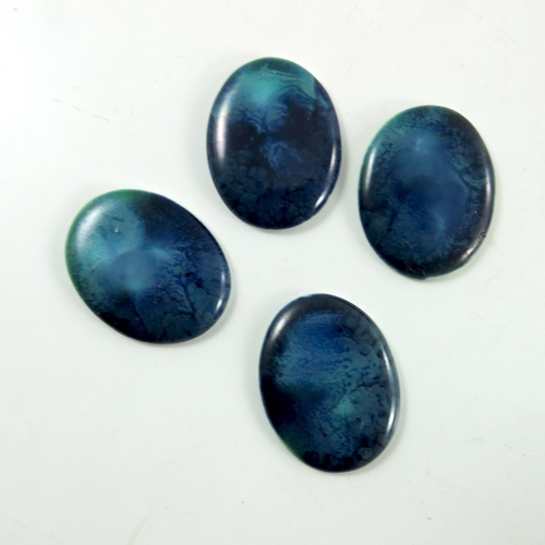 1357 - A set of four Ruskin cabochon plaques, oval form, blue and turquoise, impressed marks, 4cm long (4)