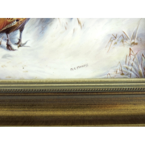 1477 - M.E. Morris, a painted porcelain plaque pheasants in the snow, signed, 16.5cm x 24.5cm, framed, note... 