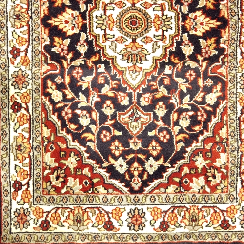 516 - A Caucasian blue and cream ground corridor runner, with floral and petal ground within a three bande... 