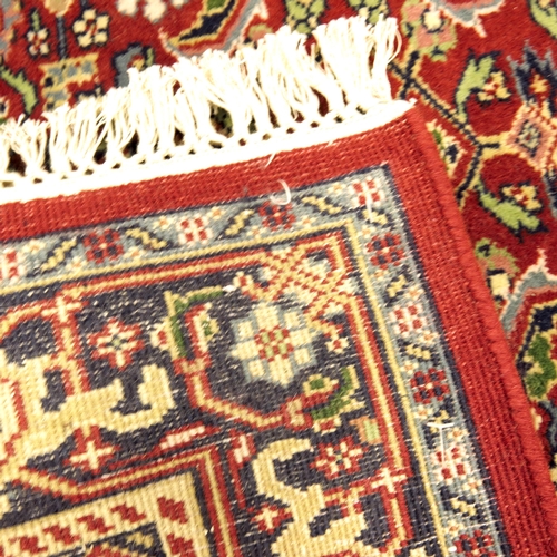 518 - A Persian style deep red ground corridor runner, 20th century, with all over stylised flower head de... 