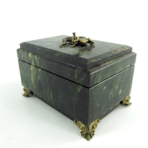 520 - A nephrite stone jewellery box, rectangular form, on ogee bracket feet, hinged lid decorated with gi... 