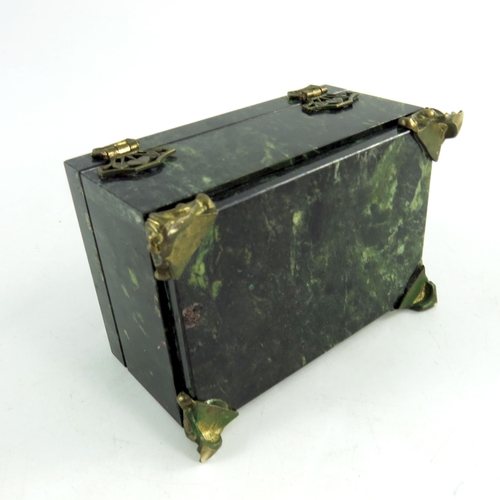 520 - A nephrite stone jewellery box, rectangular form, on ogee bracket feet, hinged lid decorated with gi... 