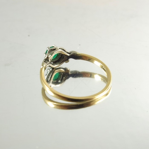 120 - An 18ct yellow gold ring inset with circular emerald in white metal decorative mount, stamped