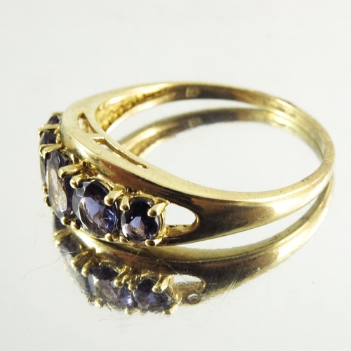 143 - A Yellow Gold Ladies Dress Ring mounted with amethysts, modern, the five graduated stones on a raise... 