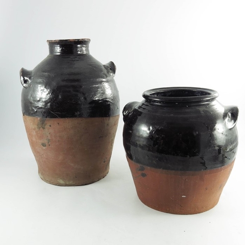 1578 - Two large Buckley slipware pots, 19th century, terracota body semi-glazed in black, 42cm highest (2)