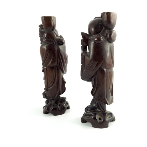 478 - Three wood carved Chinese figures, depicting a pair of sages and a parent and child riding a buffalo... 