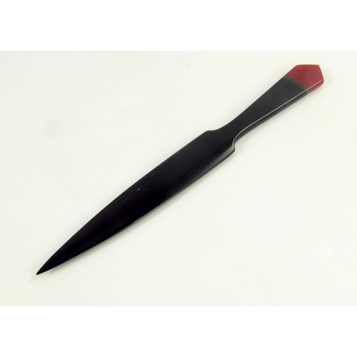 543 - An Art Deco bakelite letter opener, circa 1930 in black with red tip inlaid with green band 22cm lon... 