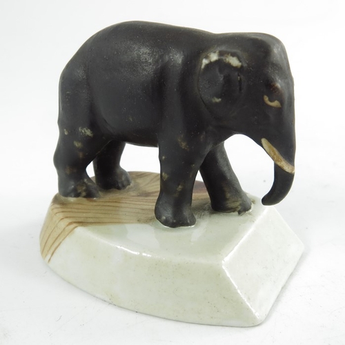 1584 - A Staffordshire elephant, circa 1860, modelled  standing on a plinth, 5cm high