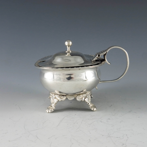 2013 - Thomas Dicks, London 1818, a George III silver oval mustard pot raised on shell scroll feet, gadroon... 