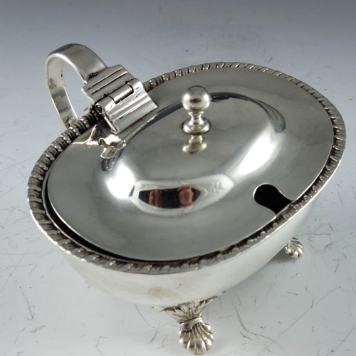 2013 - Thomas Dicks, London 1818, a George III silver oval mustard pot raised on shell scroll feet, gadroon... 