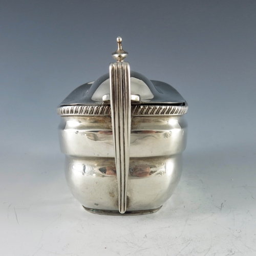 2026 - Charles Chesterman II, London 1808, a George III oval silver mustard pot with moulded girdle and gad... 