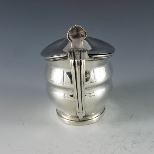 2027 - James Mince, London 1803, a George III oval silver mustard pot with moulded girdle and reeded form, ... 