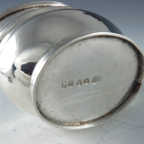 2027 - James Mince, London 1803, a George III oval silver mustard pot with moulded girdle and reeded form, ... 