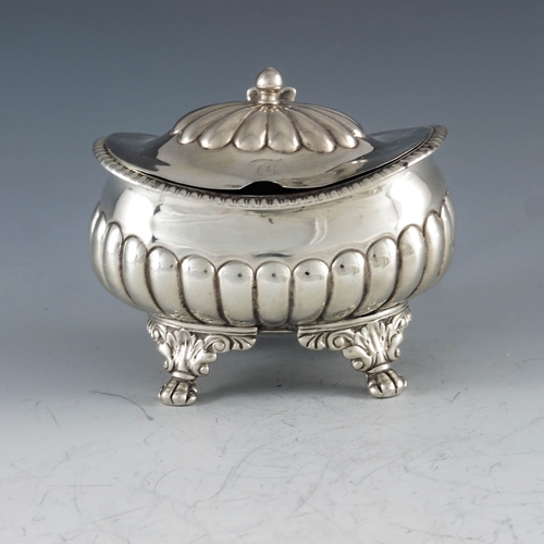 2032 - Stephen Adams, London 1818, a George III silver mustard pot, half reeded rectagular baluster form on... 