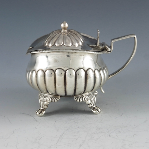 2032 - Stephen Adams, London 1818, a George III silver mustard pot, half reeded rectagular baluster form on... 