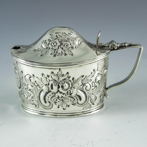 2057 - Samuel and Edward Davenport, London 1806, a George III silver mustard pot, oval boat form, embossed ... 