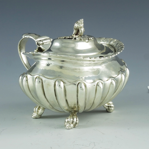 2059 - Joseph Biggs (attributed), London 1820, a George III silver mustard pot, ovoid shouldered form with ... 