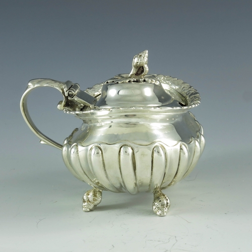 2059 - Joseph Biggs (attributed), London 1820, a George III silver mustard pot, ovoid shouldered form with ... 