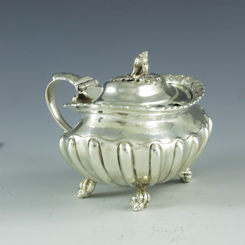 2059 - Joseph Biggs (attributed), London 1820, a George III silver mustard pot, ovoid shouldered form with ... 