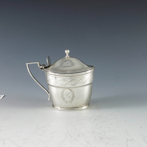 2071 - John Emes, London 1799, a George III silver mustard pot of oval navette form, the body with engraved... 