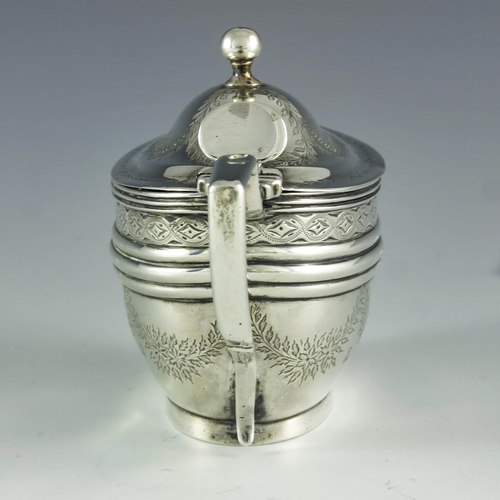 2073 - Abstainando King, London 1702, a George III silver mustard pot, bright cut oval navette form, decora... 