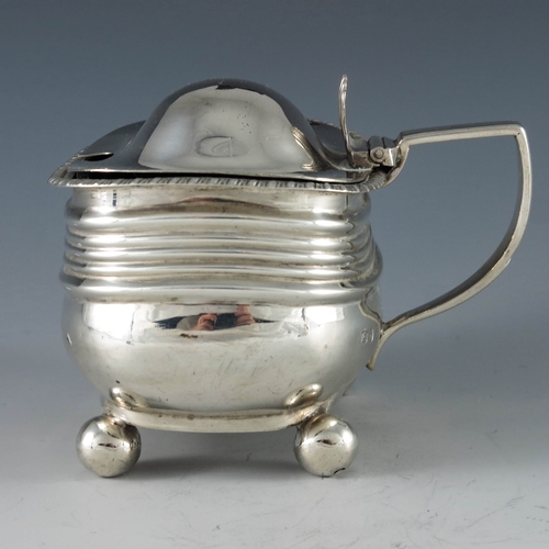 2080 - Unknown, London 1818, a George III silver mustard pot, rectangular ribbed baluster form, on four sph... 