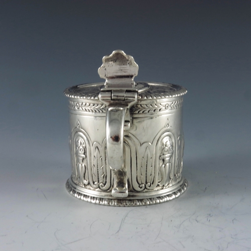 2084 - Eliza Godfrey, London 1762, a George III silver mustard pot of cylindrical form, heavily decorated w... 