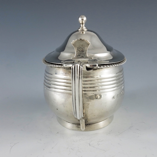 2094 - Crispin Fuller, London 1809, a George III oval silver mustard pot with moulded girdle and reeded dec... 