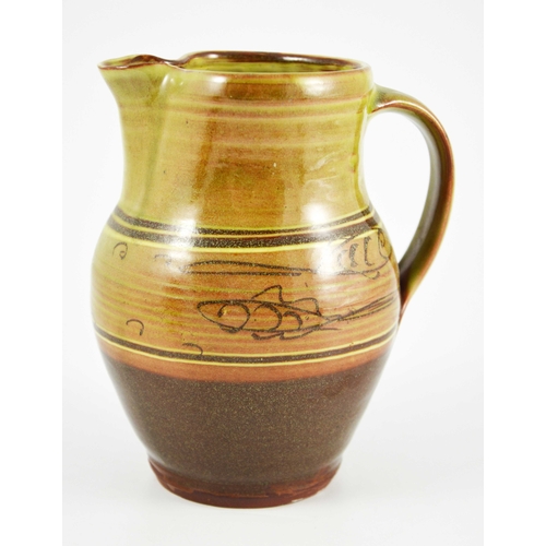 1407 - Pat Groom for Winchcombe, a studio pottery slip ware jug, decorated with a band of fish, impressed s... 