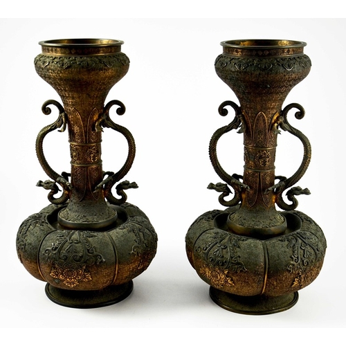 100 - A large pair of Japanese bronze vases, Meiji, melon and shaft form, heavily cast in relief with rose... 