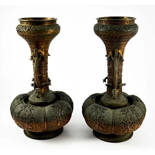 100 - A large pair of Japanese bronze vases, Meiji, melon and shaft form, heavily cast in relief with rose... 