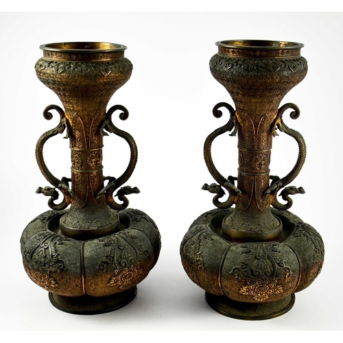 100 - A large pair of Japanese bronze vases, Meiji, melon and shaft form, heavily cast in relief with rose... 