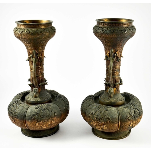 100 - A large pair of Japanese bronze vases, Meiji, melon and shaft form, heavily cast in relief with rose... 