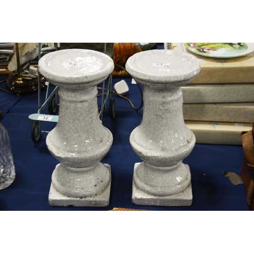 13 - A pair of terracotta white glazed baluster form pedestals.  (2)