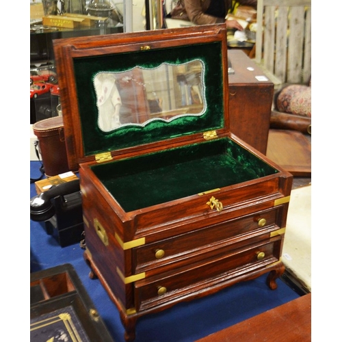 56 - An Indonesian hardwood brass inlaid vanity chest with lift up lid above two drawers on cabriole supp... 