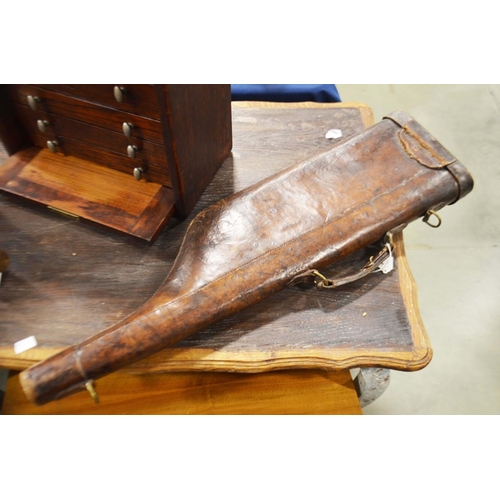 61 - A moulded leather 'leg of mutton' gun case.