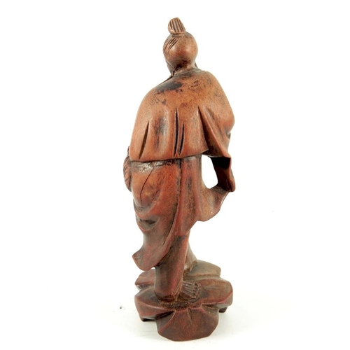 228 - A Chinese carved wood figure of a fisherman, set with glass eyes, 12.5cm high