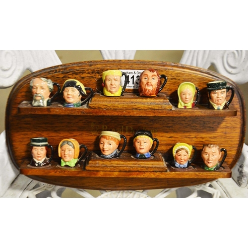 413 - Royal Doulton , a set of twelve miniature character jugs Charles Dickens series, with wooden display... 