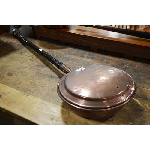 433 - A copper warming pan with turned ebonised handle.