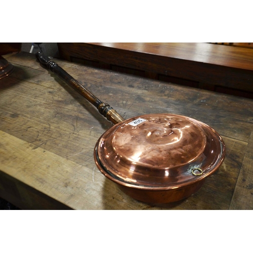 435 - A copper warming pan with turned ebonised handle.