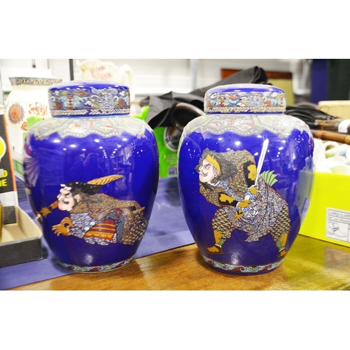 446 - A pair of Japanese porcelain ginger jars and covers, enamelled over a blue ground, decorated with Sa... 