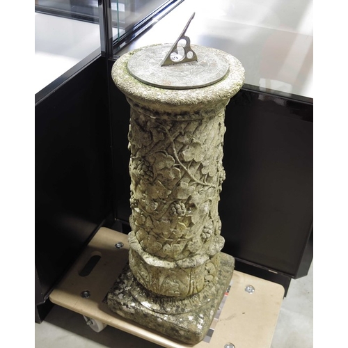 680 - A cast brass sundial on cast stone column with fruiting ivy.